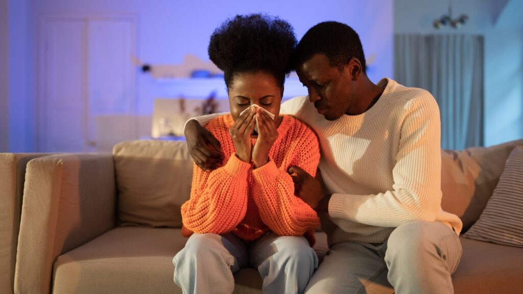 a wife crying and her husband soothing her