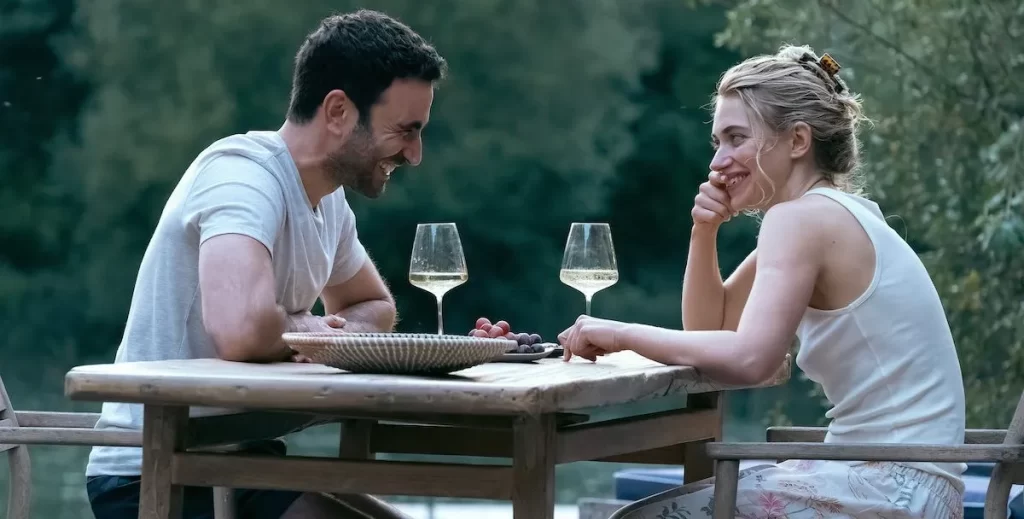 Man and woman sitting on a table