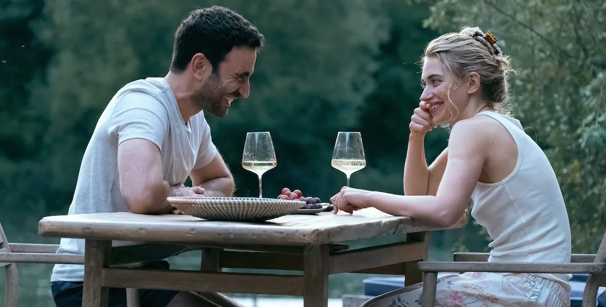 Man and woman sitting on a table